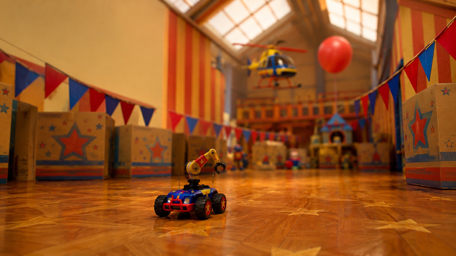 A toy RC car carrying a robot arm through a bright toy world